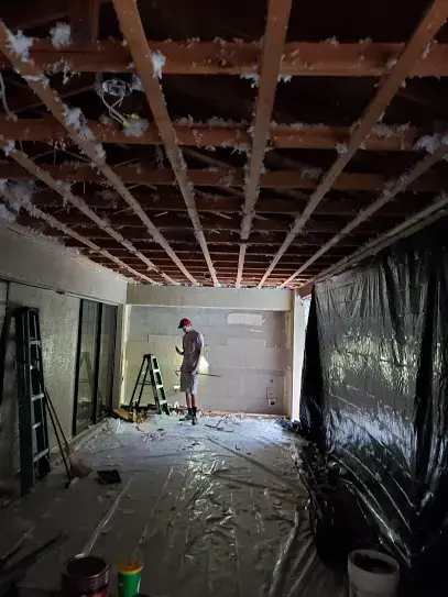 Ceiling opened to the joists with plastic containment during a Brooksville dry-out